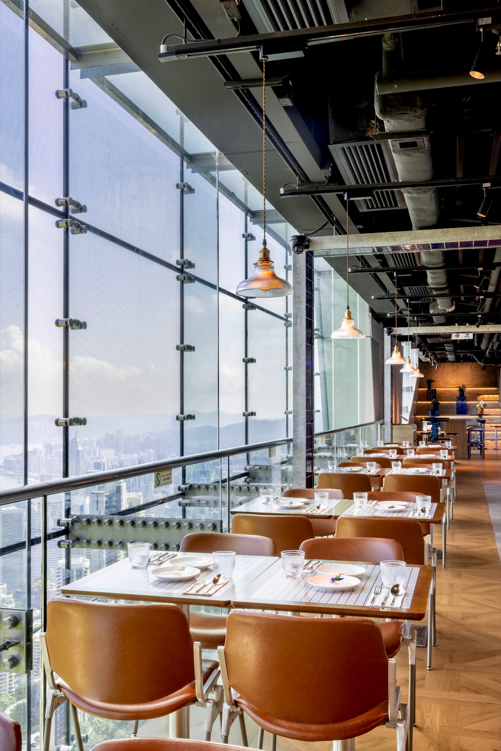 Dining tables along the harbour windows at NOOK@The Peak