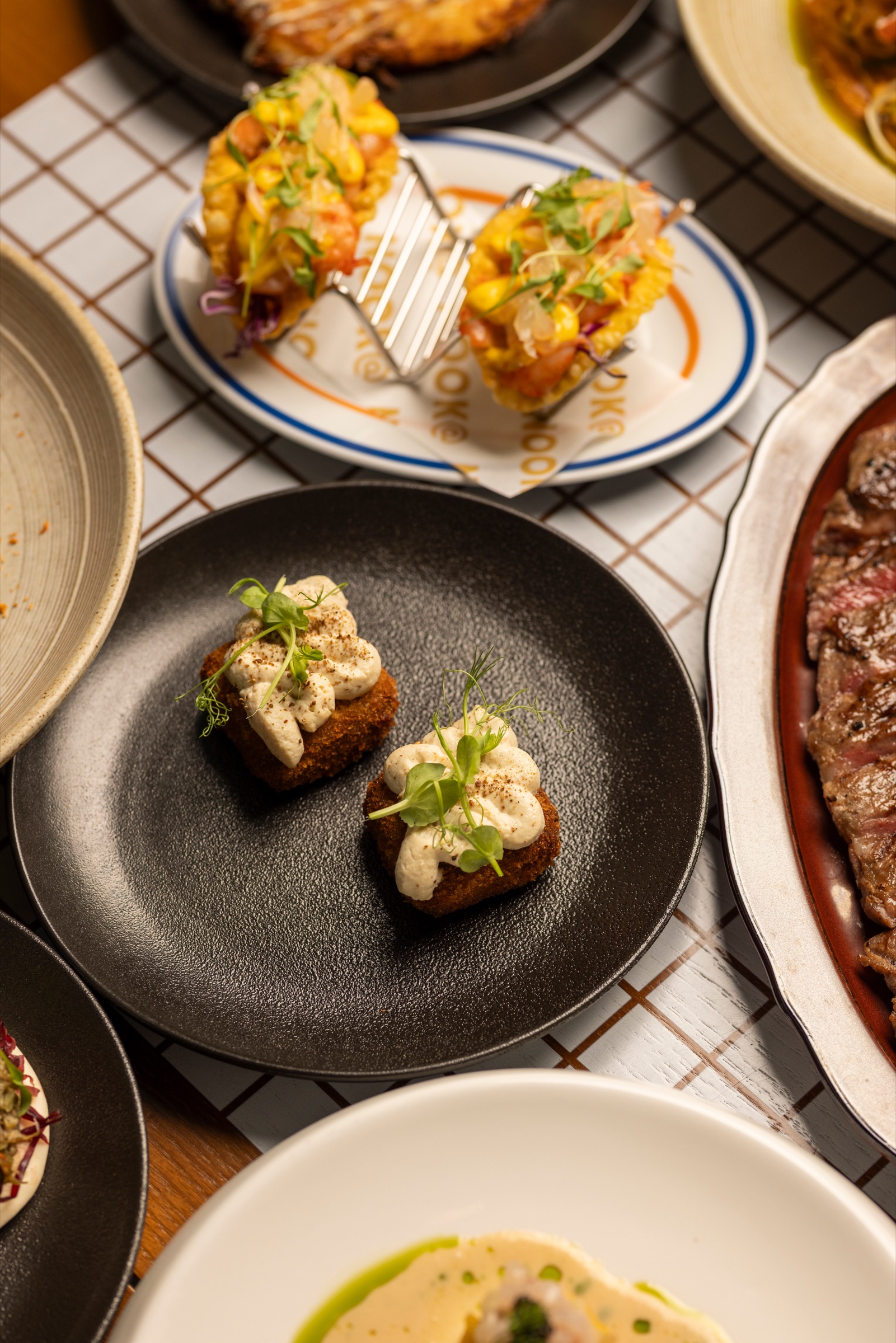 Sichuan mapo beef croquettes and wonton shrimp tacos at NOOK@The Peak